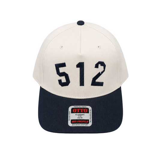 A structured baseball cap with an off-white crown and a navy blue visor, featuring the number '512' in navy on the front. The brim has a visible 'OTTO Classic OTT' brand patch.